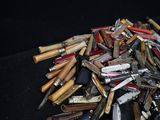 many different types of knives on a black surface