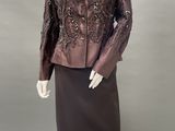 an image of a mannequin wearing a brown jacket and skirt