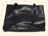 a black leather tote bag on a white background