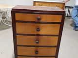 a man standing next to a dresser in a room