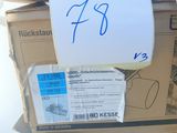 a stack of boxes with a sign on top of them