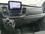 the interior of a car with a touch panel and a steering wheel