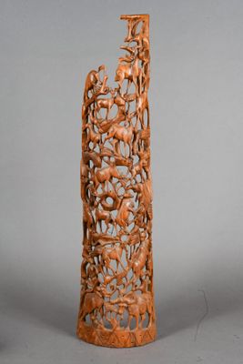 carved wooden sculpture of birds and flowers on a tall stand
