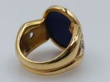 an image of a gold ring with a blue stone in the middle