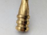 a gold colored metal object on a white surface