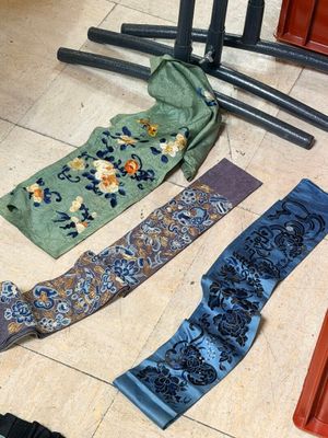 many different types of ties laid out on the floor