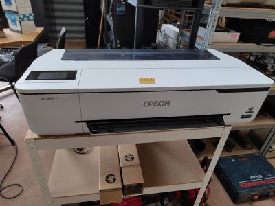 a printer sitting on top of a cart in a room