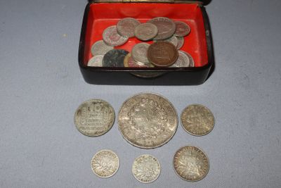 a red box filled with silver coins on a table