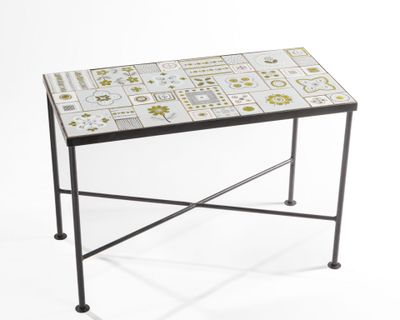 a small table with a tiled top and metal legs
