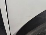 a close up of a car ' s front fender with a hole in it