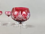 four wine glasses sitting on a table next to each other