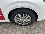a white car with a red stripe parked in a parking lot