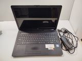 a laptop that is sitting on a table with a charger