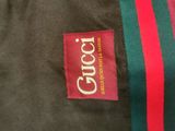 a close up of a gucci jacket with a red and green stripe