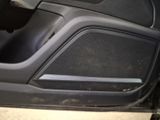 a close up of a car door with a speaker in it