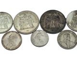 six different types of coins are shown on a white surface