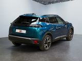 the rear end of a blue suv parked in a garage