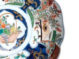 a decorative plate with a basket of flowers on it