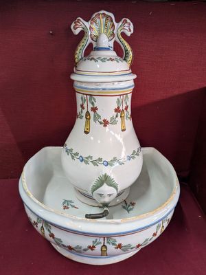 a white and blue vase and a bowl on a red surface