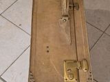 an old suitcase sitting on the floor in the bathroom