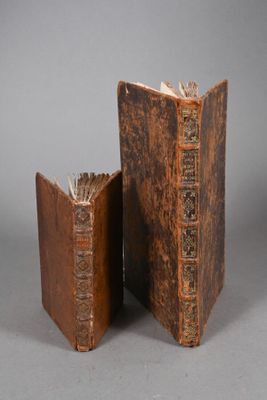two old books sitting next to each other on a table