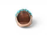 a close up of a ring with turquoise stones on it