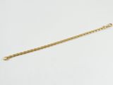 un bracelet à chaîne en or avec un fermoir sur fond blanc
