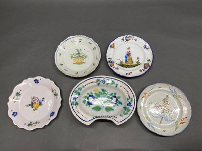 four plates with different designs on them sitting on a table