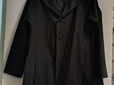 jacket hanging on a wall in a room with a bed and a window