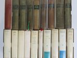several old books are stacked on top of each other on a table