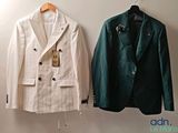 two jackets hanging on a wall next to each other