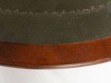 a green hat on top of a wooden table