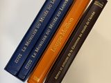 three books that are sitting on top of a table