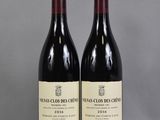 two bottles of wine sitting on top of a table next to each other