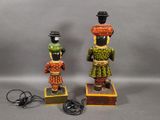 two figurines of a man and a woman with hats on their heads