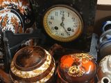 a clock sitting on top of a table next to other items