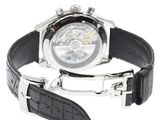 the watch has a black strap around the wrist and a silver case