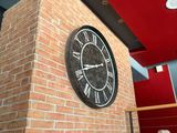 a clock that is on the side of a brick wall