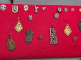 a red purse with many different types of badges on it