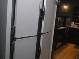 two refrigerators that are sitting in the kitchen