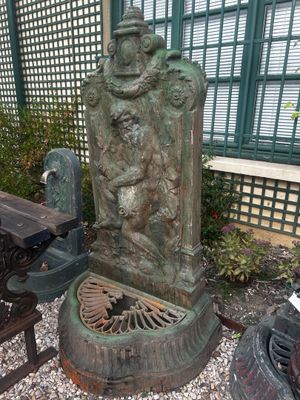 a statue of a man on a bench next to a fire hydrant