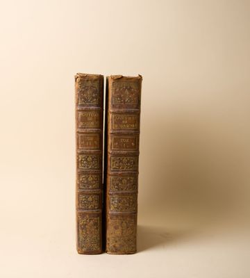 deux vieux livres posés l'un sur l'autre sur une table