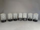 six clear glass tumbles lined up in a row on a table