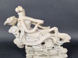 an image of a statue of a woman sitting on top of a cloud