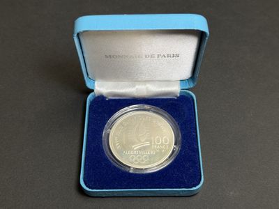 a close up of a coin in a blue box on a table