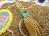 some wooden spoons are sitting on top of a rope mat