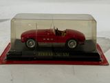 a red car in a glass case on a white surface