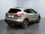 the rear end of a silver nissan qx - v parked in a room
