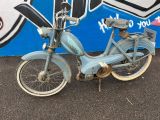 a blue motorcycle parked in front of a graffiti covered wall