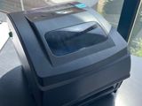 a small printer sitting on top of a table next to a window